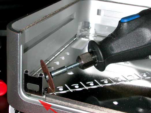 Cut the metal anchor for the security slot off before putting the cover back on. Cut it flush with the Mini's casing.